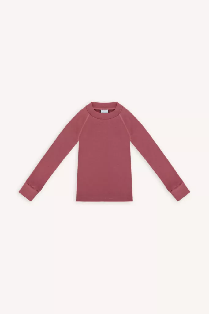 Dětský top s dlouhým rukávem ze 100% merino vlny ve starorůžové (180 g) leží naplocho, má minimalistický design a kulatý výstřih.